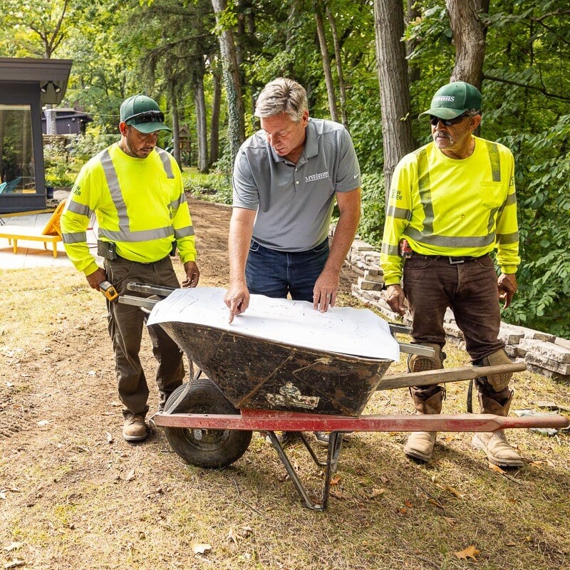 Residential landscape crew looking at design plan 2