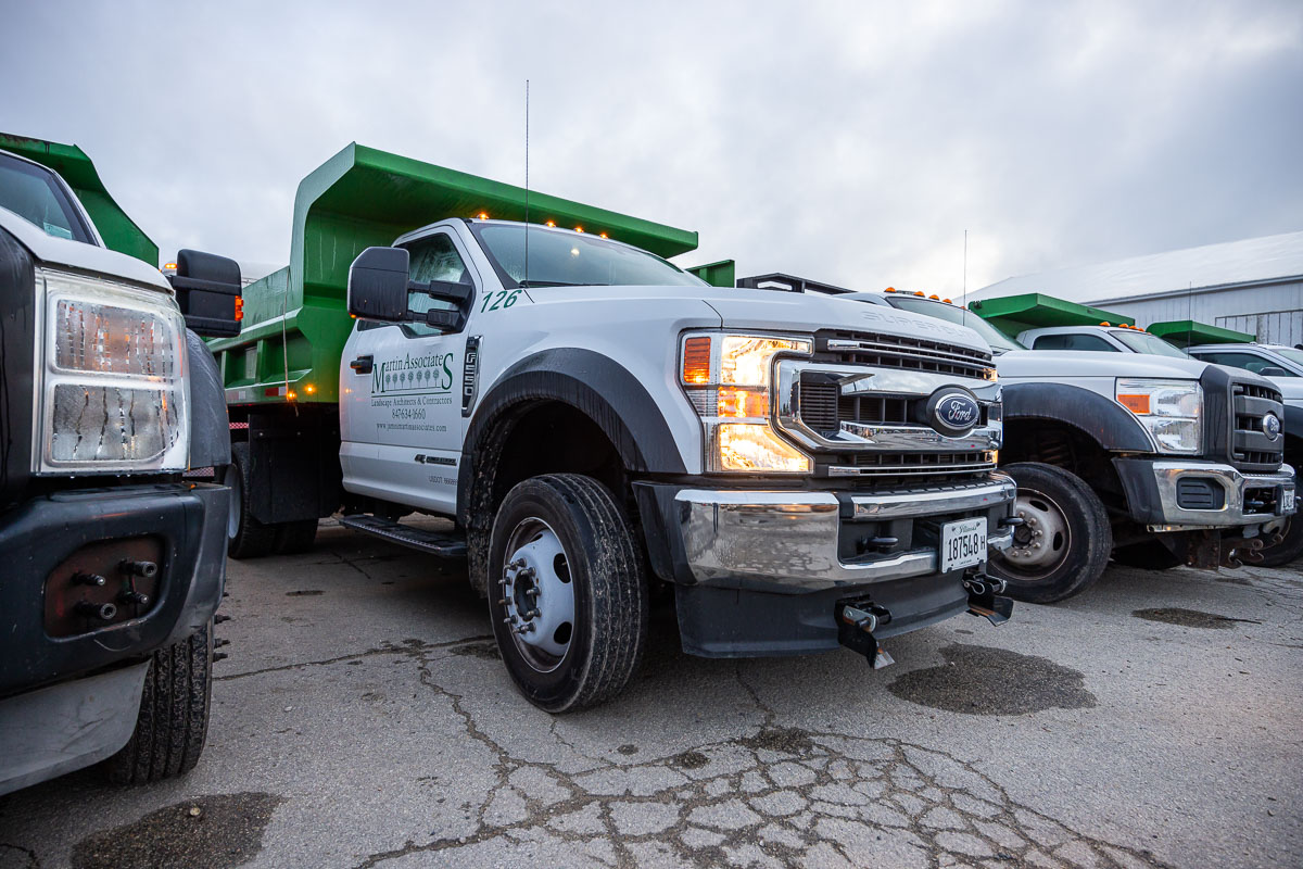 close up of trucks leaving shop in the morning